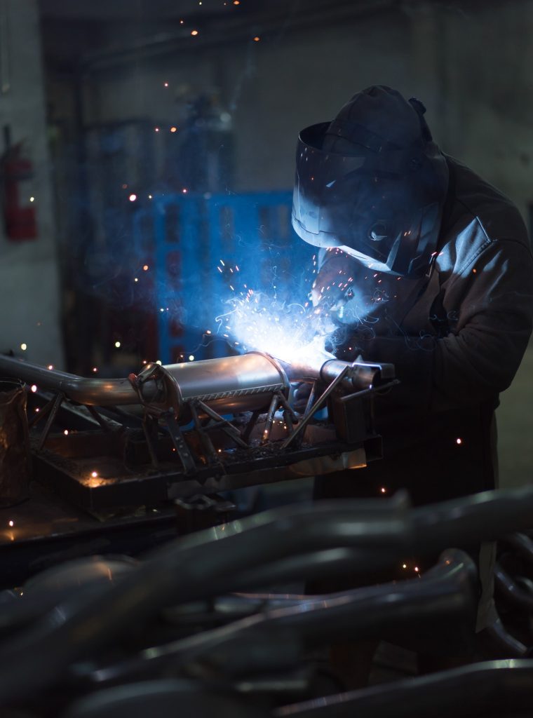 worker-welding-exhaust-pipes-pieces-together.jpg worker-welding-exhaust-pipes-pieces-together.jpg